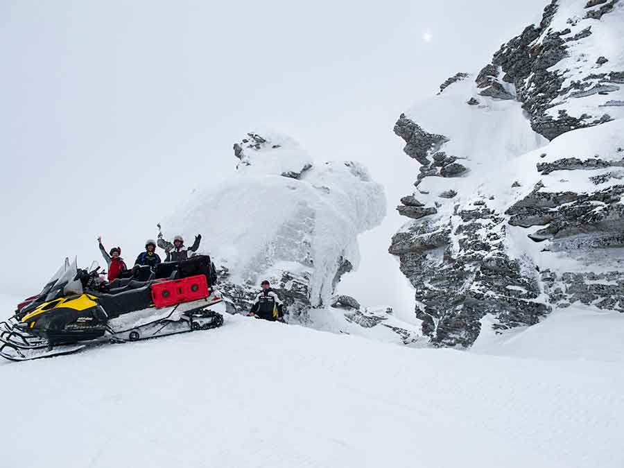 Dan Gould and snowmobilers at the Manpupuner Rock Formations at the top of Oslyanka Mountain in the Russian Urals.