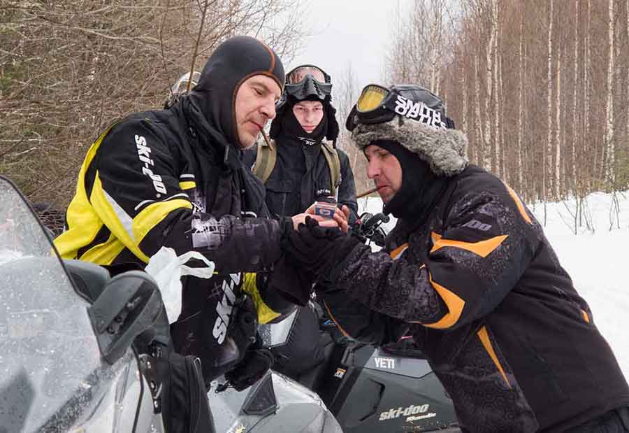 Russian snowmobilers smoke cigars