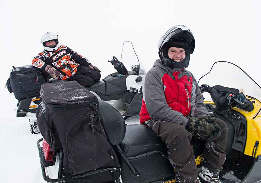 Sergey Valeev and Vlad Klekney on snowmobiles in the Russian Ural Mountains.