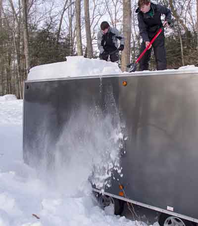 Clear the snow off your snowmobile trailer
