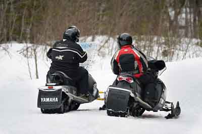 Snowmobilers look at map in NH