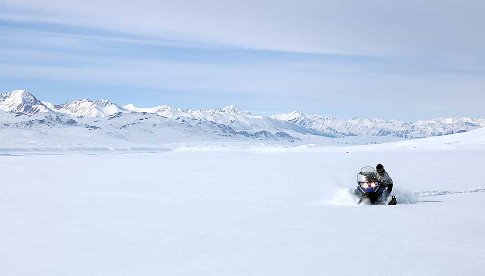 Snowmobiling in field Tian-Shan Mountains of Kyrgyzstan