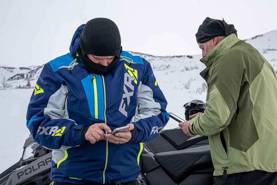 Snowmobilers use cell phones in Alaska