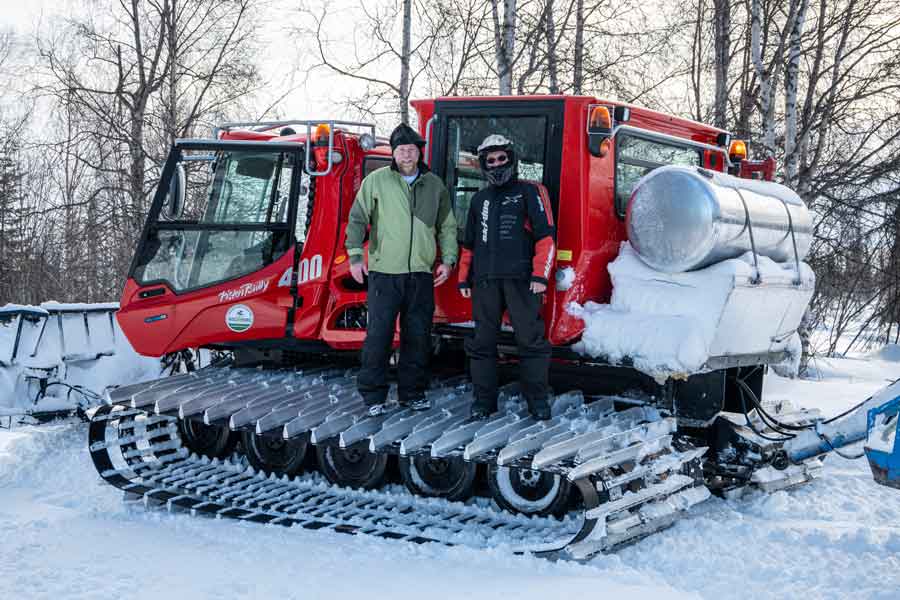 Chris Gamache and Roger Wright check-out the snowmobile trail groomer operated by the Petersville Community Non-Profit Corporation.