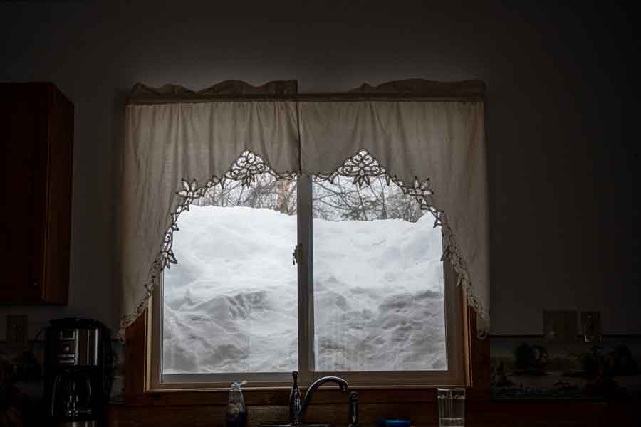 Snow piled high outside the window at Gate Creek Cabins in Petersville, Alaska.
